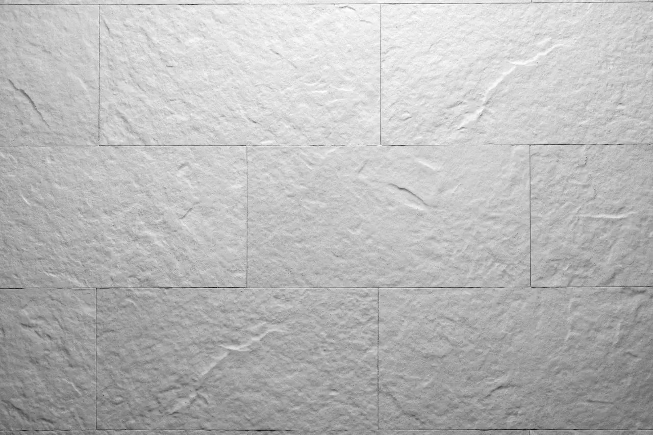 White R01 Mont Blanc flexible tile with a natural stone relief laid with staggered joints