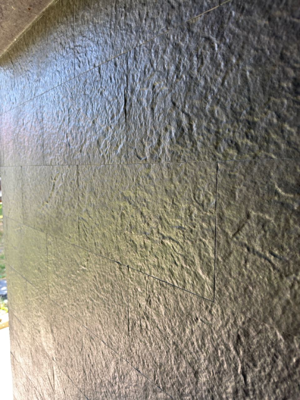 Close-up of the texture of the dark flexible stone plinth